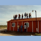 thumbnail The group stands on the roof in triumph.